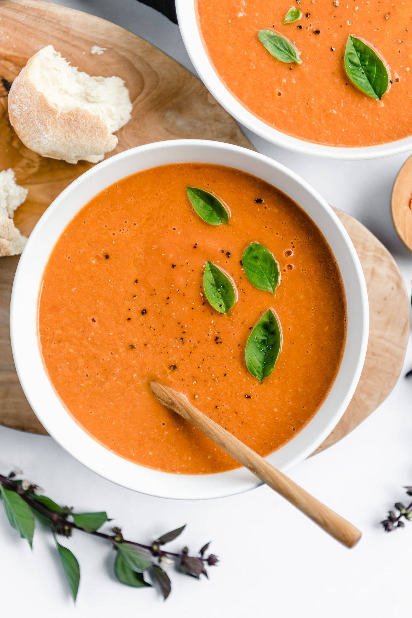 tomato soup with basil garnish and crusty bread