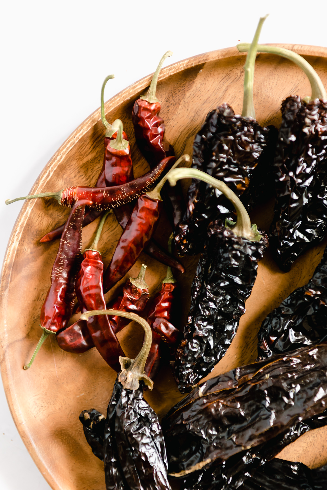dehydrated hot peppers on a wooden plate